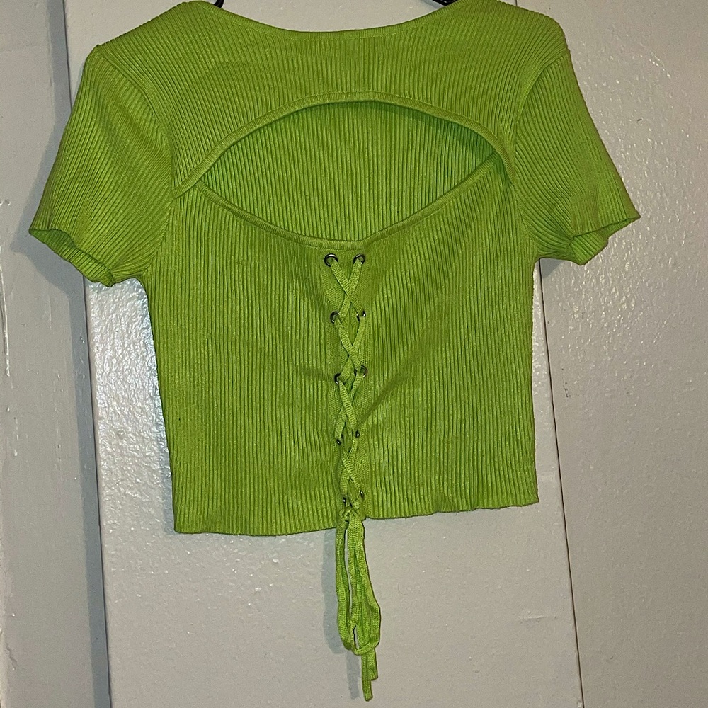 A neon green opened chest knitted crop (top piece)